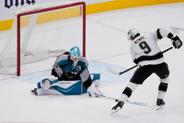 San Jose Sharks goaltender Yaroslav Askarov, left, stops the puck...