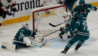 Ottawa Senators center Tim St&uuml;tzle (18) scores a goal past San Jose Sharks goaltender Alex Nedeljkovic (33), center Nick Cousins, top right, and right wing Ryan Reaves during the third period of an NHL hockey game in San Jose, Calif., Saturday, Nov. 22, 2025. (AP Photo/Jeff Chiu)