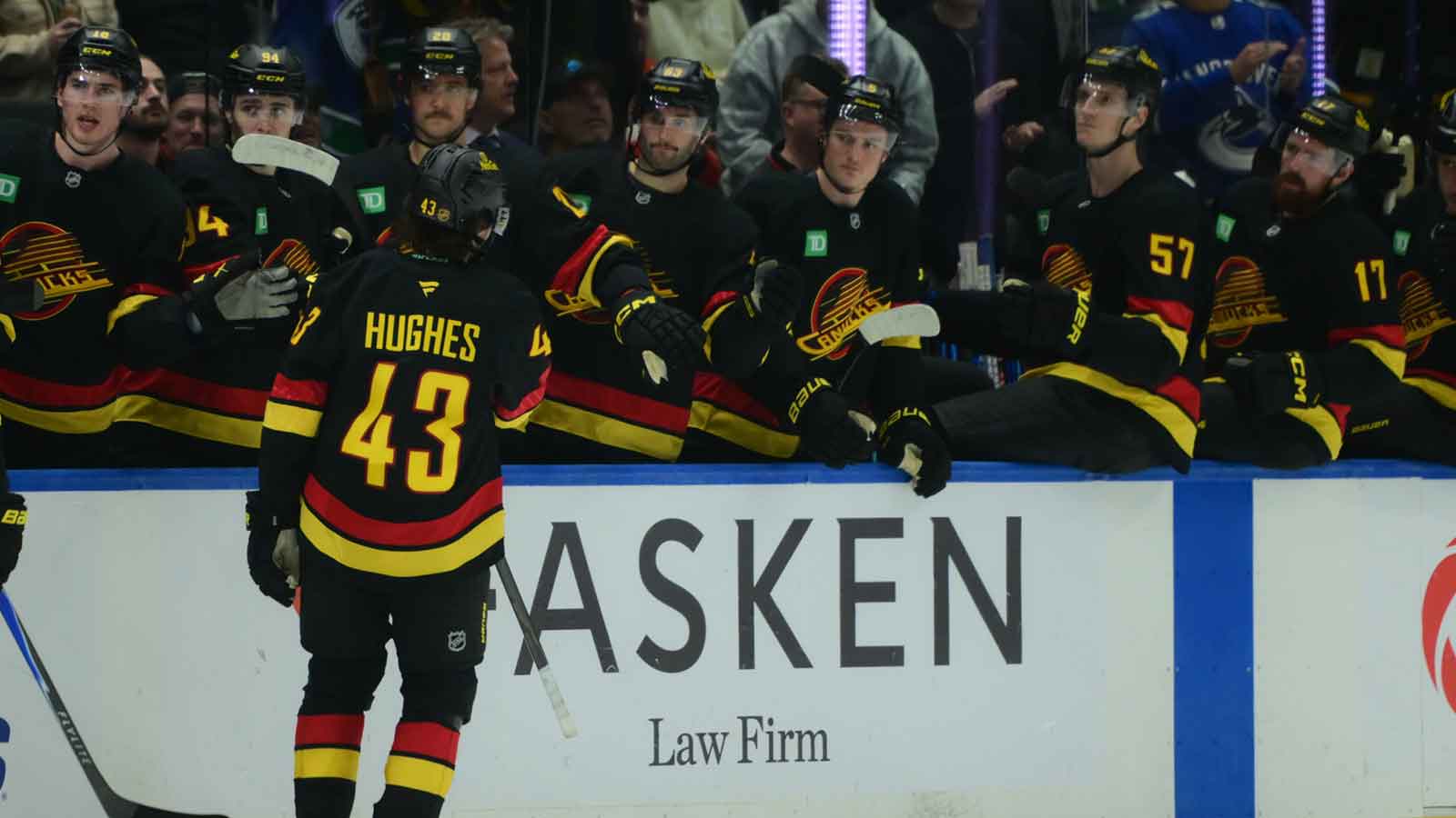 Vancouver Canucks defenseman Quinn Hughes (43) celebrates scoring with teammates on the bench during the third period against the Calgary Flames at Rogers Arena.