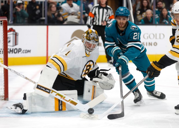 San Jose Sharks' Alexander Wennberg (21) tries to get the...