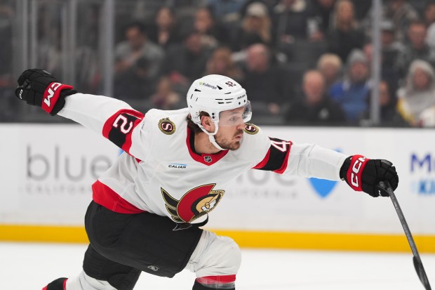 Ottawa Senators right wing Hayden Hodgson reaches for the puck...