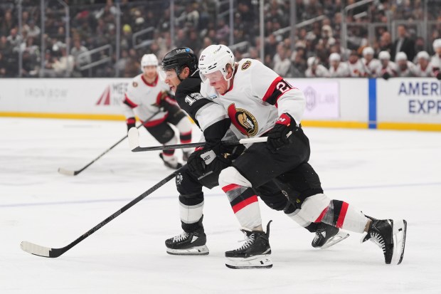 Kings left wing Trevor Moore, left, and Ottawa Senators left...