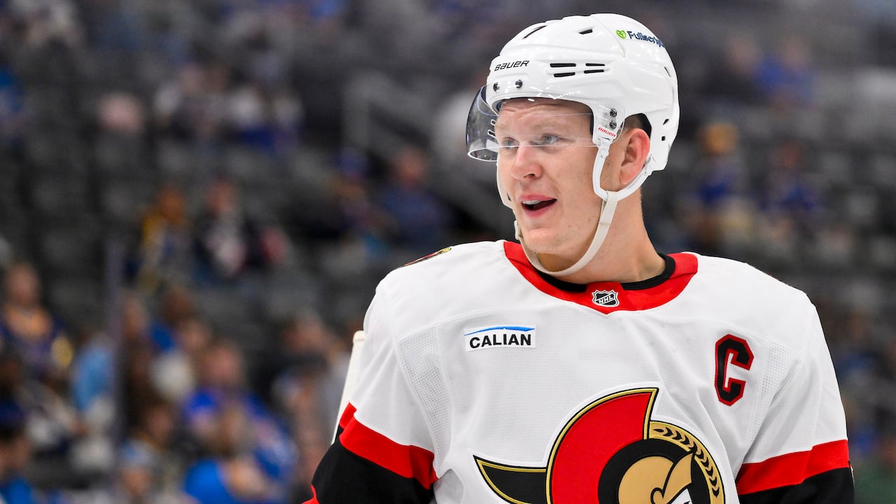 A hockey player looks on during a pre-season game.