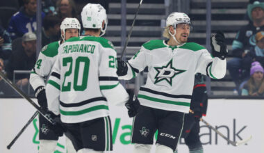 Dallas Stars center Roope Hintz, right, celebrates with defenseman Kyle Capobianco (20) and left wing Jamie Benn (14) after scoring during the first period of an NHL hockey game against the Seattle Kraken Wednesday, Nov. 26, 2025, in Seattle. (AP Photo/Jason Redmond)
