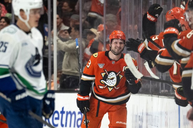 Ducks center Mason McTavish celebrates his goal with the bench...