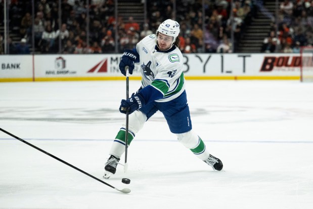 Vancouver Canucks defenseman Quinn Hughes shoots the puck during the...