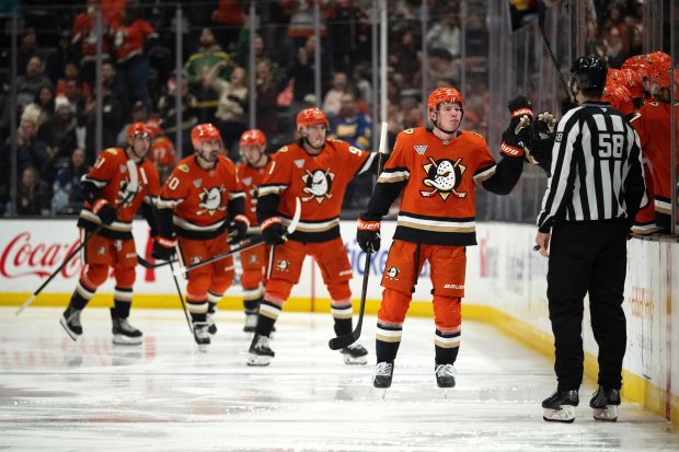 Ducks defenseman Jackson Lacombe (2) celebrates his goal with the...
