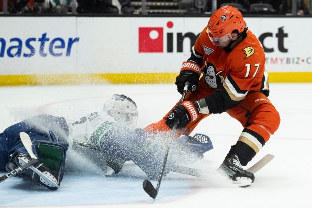 Vancouver Canucks goaltender Nikita Tolopilo, left, stops the puck in...