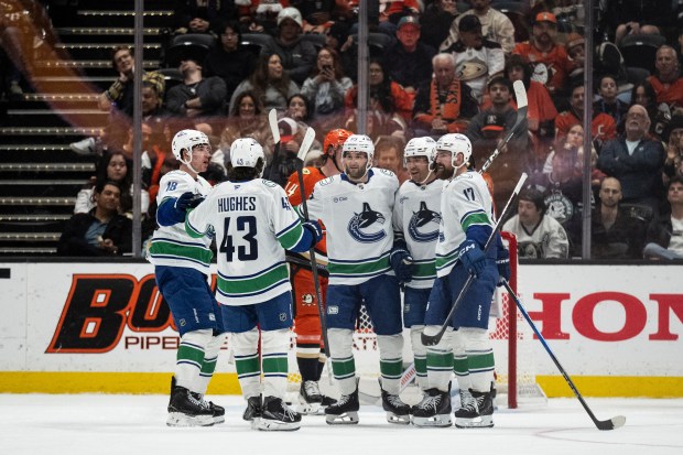 Vancouver Canucks players celebrate a goal by center Max Sasson...