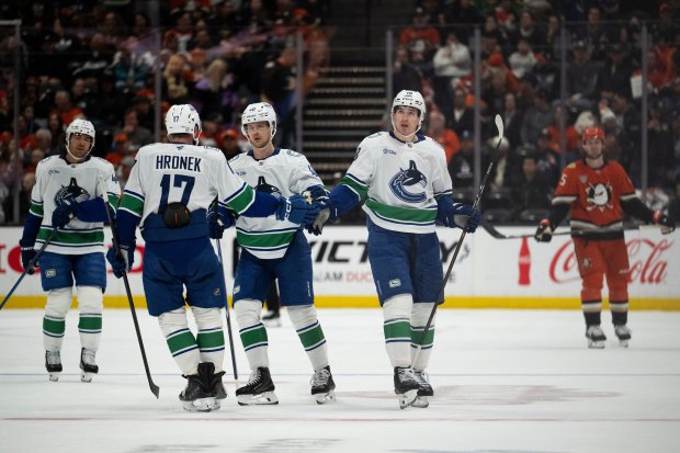 Vancouver Canucks left wing Drew O’Connor (18) celebrates his empty-net...