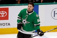 Dallas Stars defenseman Lian Bichsel (6) warms up before making his NHL debut against the...