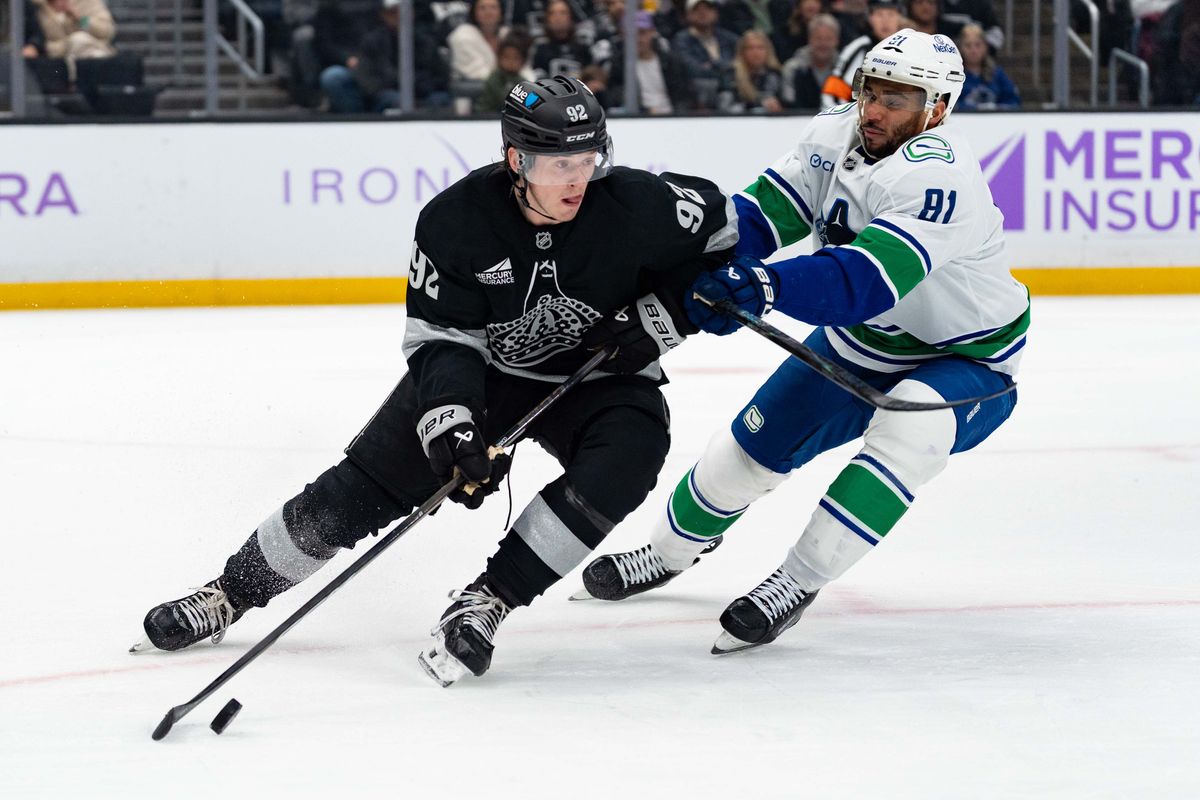 Los Angeles Kings defenseman Brandt Clarke (92) clears the puck during an NHL game between the Vancouver Canucks and the Los Angeles Kings, Saturday November 29, 2025 at Crypto.com Arena in Los Angeles, Calif.