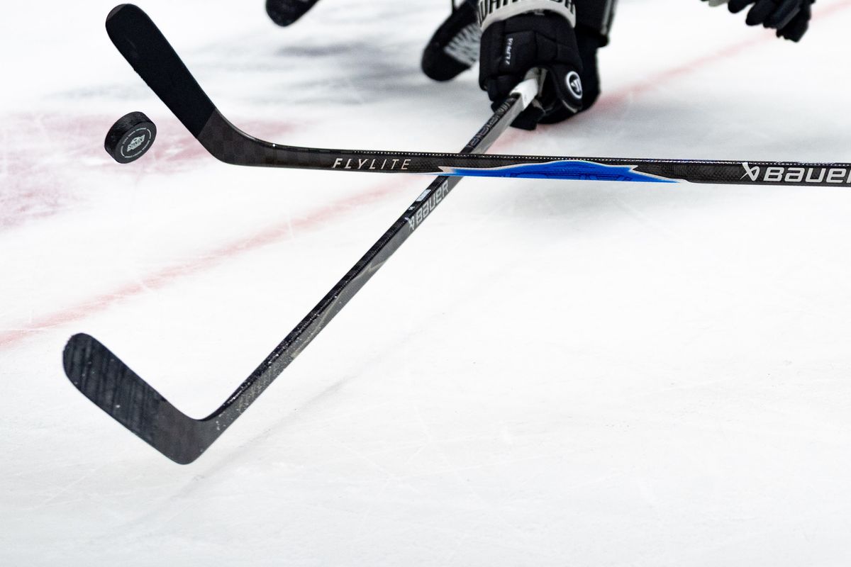 Players fight for the puck during an NHL game between the Vancouver Canucks and the Los Angeles Kings, Saturday November 29, 2025 at Crypto.com Arena in Los Angeles, Calif.