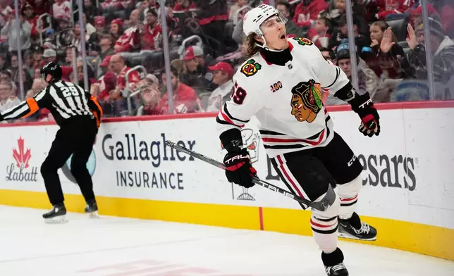 Chicago Blackhawks left wing Tyler Bertuzzi, right, celebrates after scoring during the third period of an NHL hockey game against the Detroit Red Wings, Sunday, Nov. 9, 2025, in Detroit. (AP Photo/Ryan Sun)