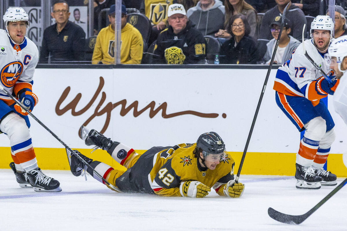 Golden Knights right wing Braeden Bowman (42) is taken down as he drives with the puck against ...