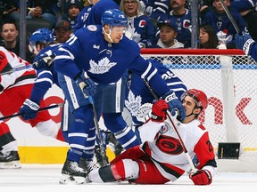 Dakota Joshua of the Toronto Maple Leafs checks Seth Jarvis of the Carolina Hurricanes.