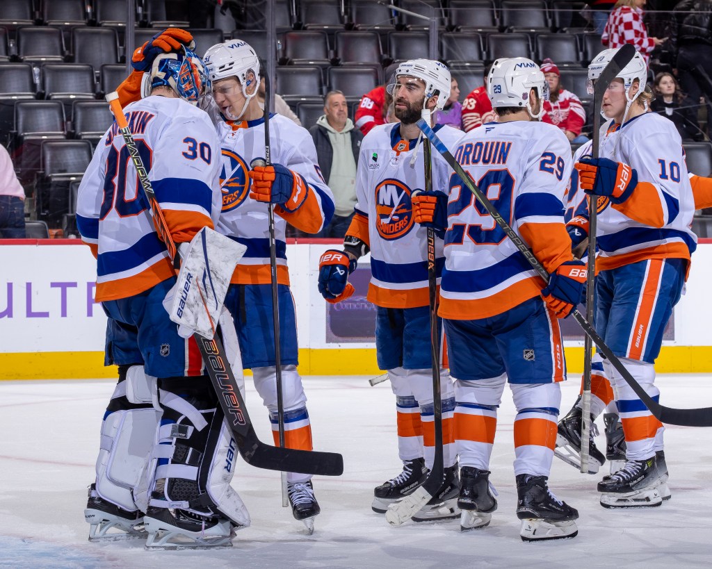  Emil Heineman #51 of the New York Islanders bumps helmets with teammate Ilya Sorokin #30 after the shut out win against the Detroit Red Wings during the third period at Little Caesars Arena on November 20, 2025 in Detroit, Michigan. 