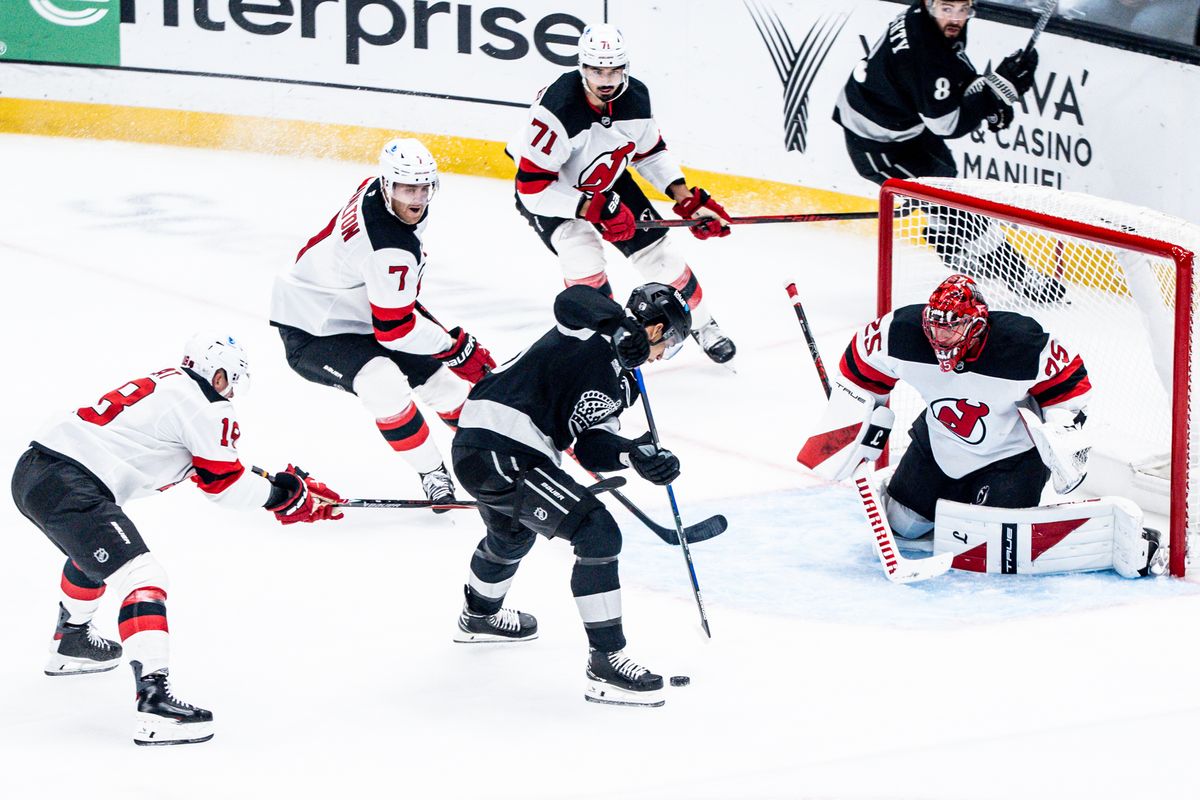 Los Angeles Kings player goes between defenders and tries to score during an NHL game against the New Jersey Devils, Saturday November 1st, 2025 in Los Angeles, California. 