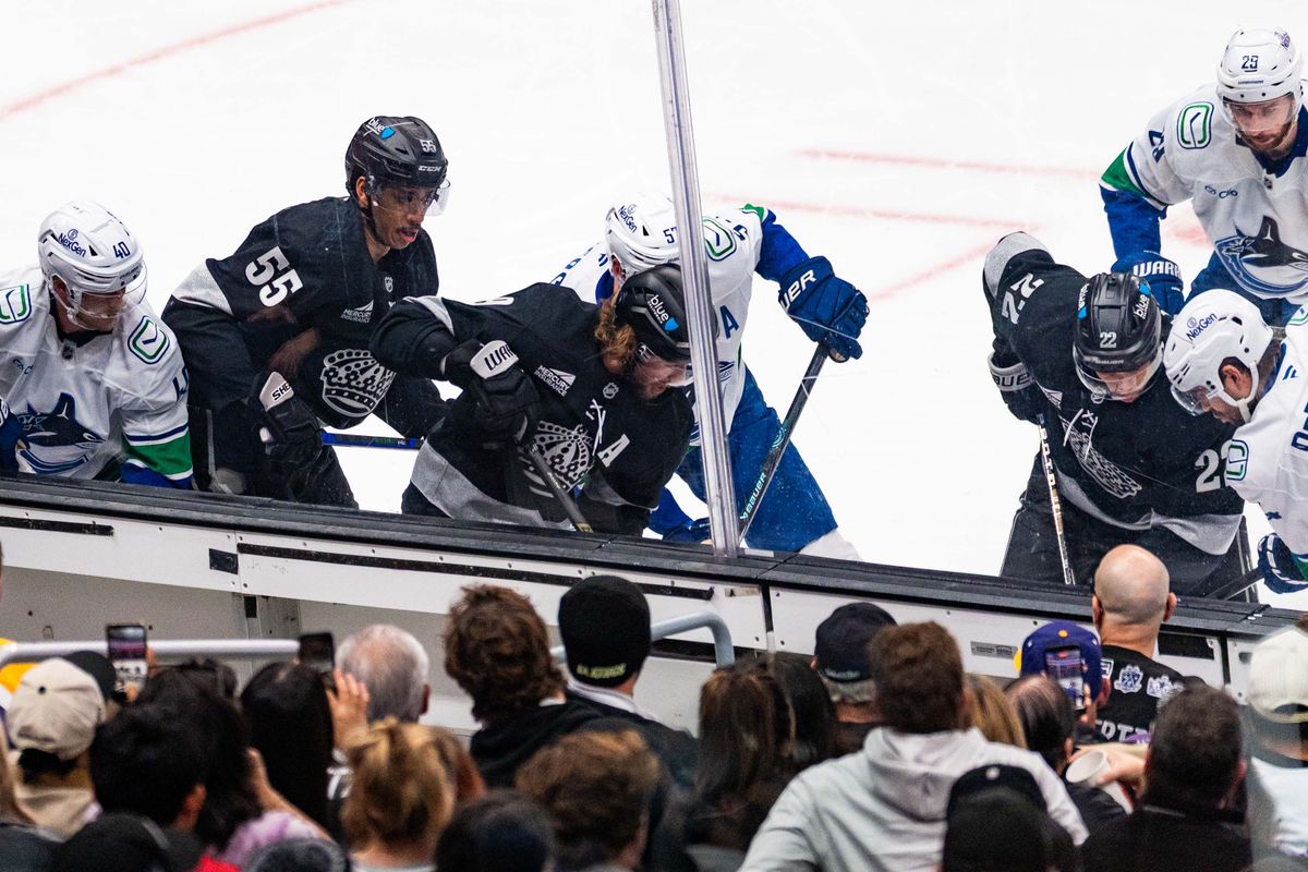 Players fight for the puck during an NHL game between the Vancouver Canucks and the Los Angeles Kings, Saturday November 29, 2025 at Crypto.com Arena in Los Angeles, Calif.