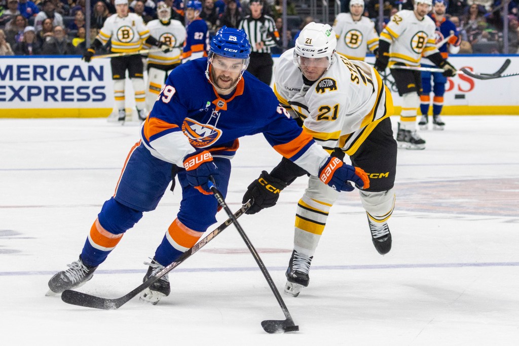 Jonathaoun Drouin (left) looks to keep the puck away from Alex Steeves during the Islanders' loss to the Bruins.