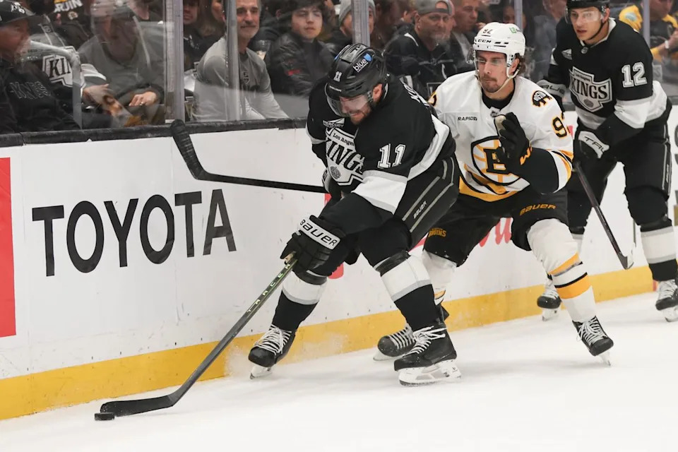Center Anze Kopitar #11 of the Los Angeles Kings handles the puck along the boards during an NHL hockey game against the Boston Bruins, Friday November 21, 2025 in Los Angeles, Calif.