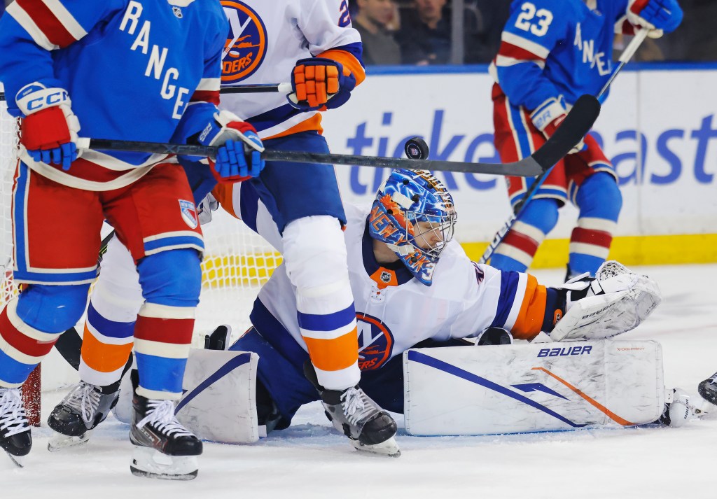 New York Islanders goalie Ilya Sorokin making a save during a hockey game against the New York Rangers.