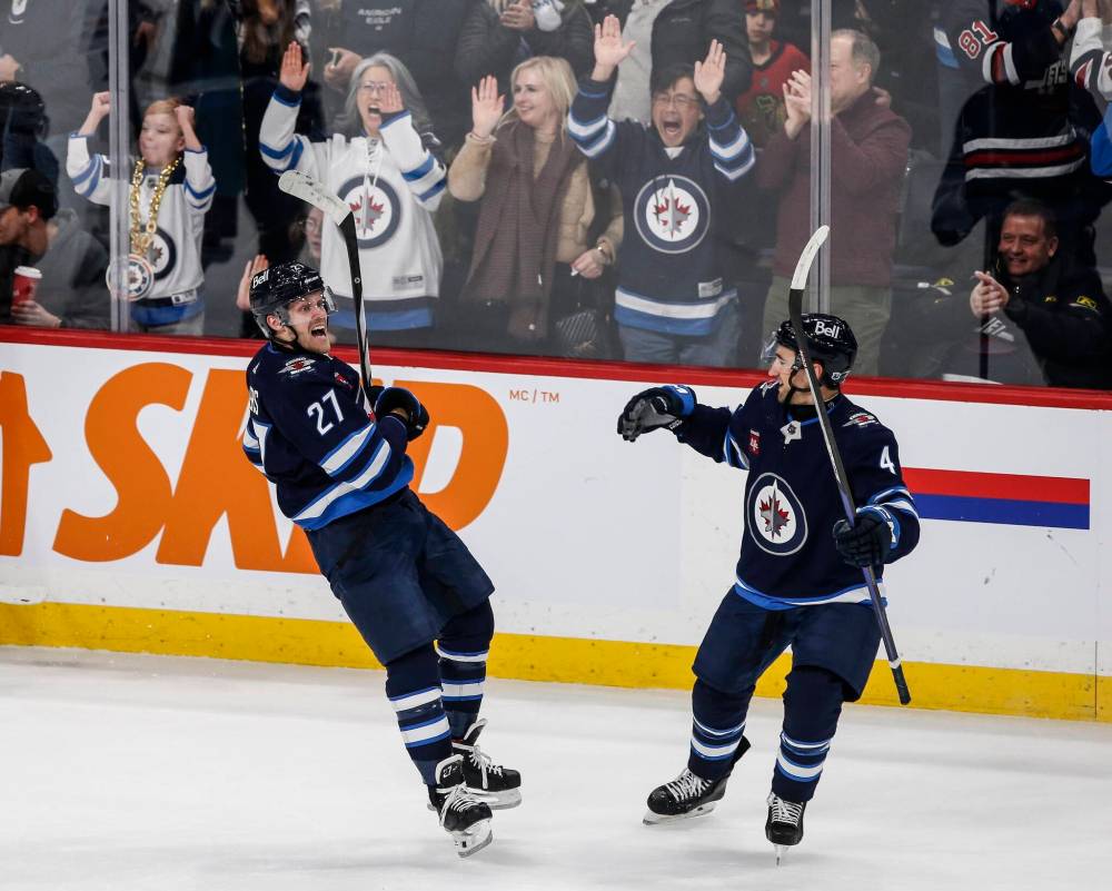 John Woods / THE CANADIAN PRESS FILES
Winnipeg Jets’ Neal Pionk (right) celebrates last season with then teammate Nikolaj Ehlers. Pionk is looking forward to getting into his former teammate’s head when Ehlers rolls into town Friday with the Carolina Hurricanes.
