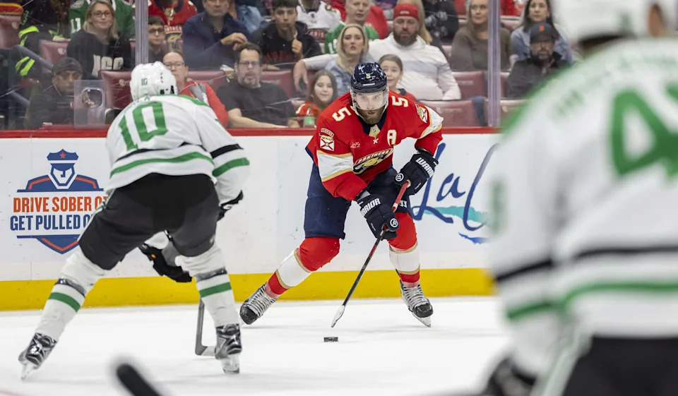 Florida Panthers defenseman Aaron Ekblad (5) looks to pass the puck a Dallas Stars center Oskar Bäck (10) defends in the second period of an NHL game at Amerant Bank Arena on Saturday, Nov. 1, 2025, in Sunrise, Fla.