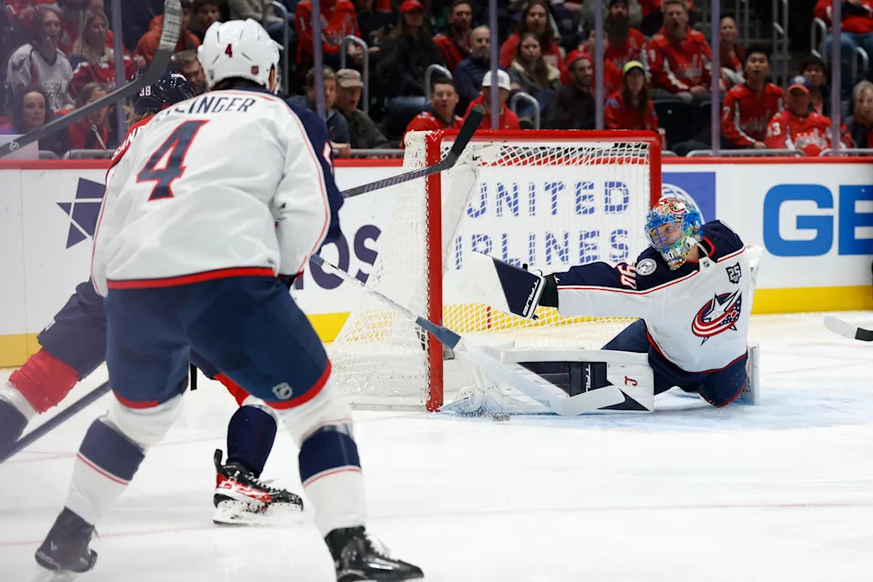 Nov 24, 2025; Washington, District of Columbia, USA; Columbus Blue Jackets goaltender Elvis Merzlikins (90) makes a save against on Washington Capitals defenseman Rasmus Sandin (38) during the first period at Capital One Arena. Mandatory Credit: Geoff Burke-Imagn Images