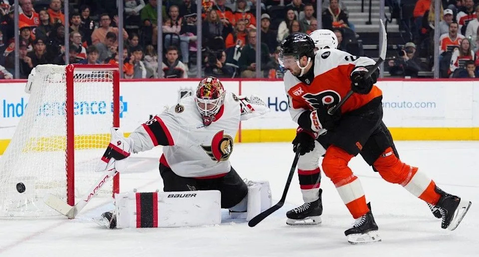  Senators goaltender Linus Ullmark makes a save as defenceman Jake Sanderson, rear, and the Flyers’ Noah Cates (27) race for the puck during the second period of Saturday’s contest.