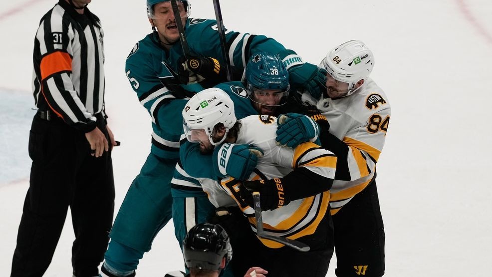 San Jose Sharks defenseman Vincent Desharnais, second from top left, and Boston Bruins left wing Tanner Jeannot (84) try to separate Sharks defenseman Mario Ferraro, middle, and Bruins center Mark Kastelic (47) after an NHL hockey game in San Jose, Calif., Sunday, Nov. 23, 2025. (AP Photo/Jeff Chiu)