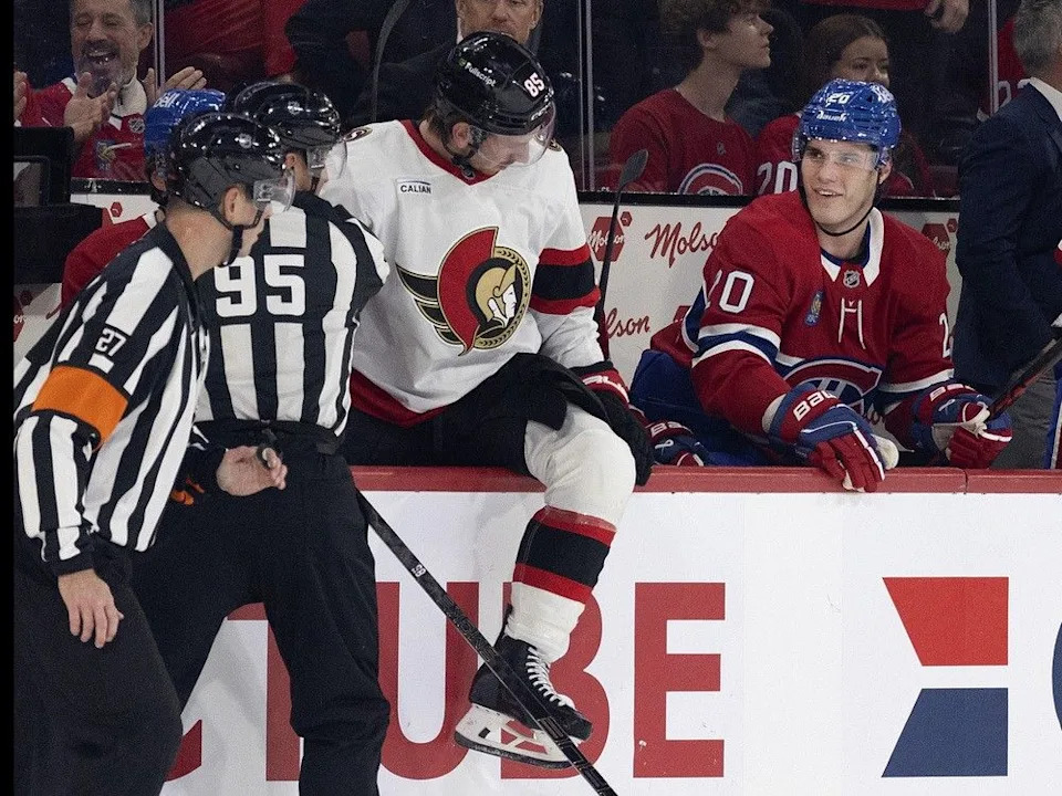  Senators defenceman Jake Sanderson (85) gets a snide look from Canadiens forward Juraj Slafkovsky as he climbs out of the Montreal bench after taking a big hit during Saturday’s game.
