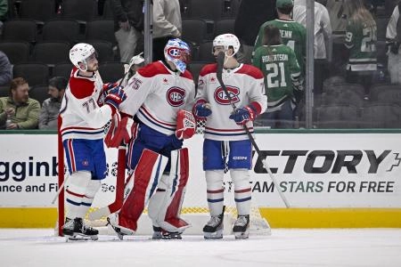 Jan 16, 2025; Dallas, Texas, USA; Montreal Canadiens center Kirby Dach (77) and goaltender Jakub Dobes (75) and defenseman Arber Xhekaj (72) celebrate on the ice after defeating the Dallas Stars at the American Airlines Center. Mandatory Credit: Jerome Miron-Imagn Images