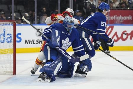 Toronto Maple Leafs goaltender Anthony Stolarz (41) goes to make a save as defenseman Phillipe Myers (51) clears Calgary Flames forward Nazem Kadri