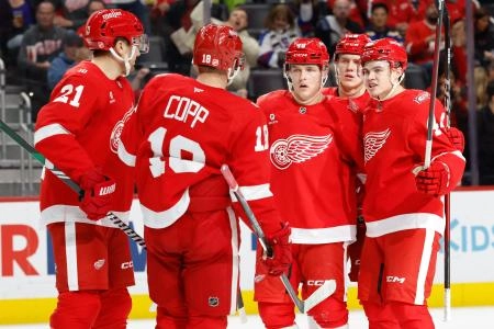 Oct 25, 2025; Detroit, Michigan, USA; Detroit Red Wings right wing Jonatan Berggren (48) receives congratulations from teammates after scoring in the second period against the St. Louis Blues at Little Caesars Arena. Mandatory Credit: Rick Osentoski-Imagn Images