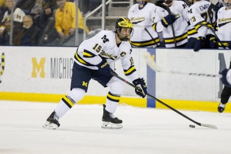 March 8, 2025; Ann Arbor, Michigan, USA; Michigan Wolverines defenseman Jacob Truscott (15) handles the puck during the first period against the Penn State Nittany Lions at Yost Ice Arena. Mandatory Credit: Brian Bradshaw Sevald-Imagn Images