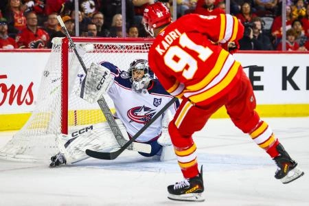 Nov 5, 2025; Calgary, Alberta, CAN; Calgary Flames center Nazem Kadri (91) scores a goal against Columbus Blue Jackets goaltender Jet Greaves (73) during the second period at Scotiabank Saddledome