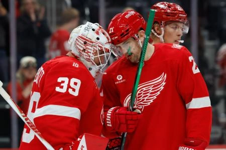 Oct 15, 2025; Detroit, Michigan, USA; Detroit Red Wings goaltender Cam Talbot (39) and left wing James van Riemsdyk (21) celebrate after defeating the Florida Panthers at Little Caesars Arena. Mandatory Credit: Rick Osentoski-Imagn Images