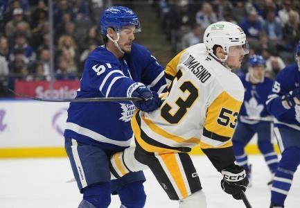 Nov 3, 2025; Toronto, Ontario, CAN; Toronto Maple Leafs defenseman Philippe Myers (51) clears Pittsburgh Penguins forward Philip Tomasino (53) away from the net during the second period at Scotiabank Arena. Mandatory Credit: John E. Sokolowski-Imagn Images