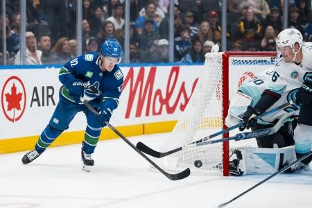 Vitali Kravtsov attempts to make a pass during a preseason game between the Vancouver Canucks  Seattle Kraken.