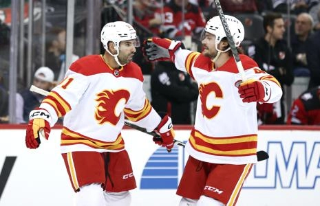 Nov 8, 2022; Newark, New Jersey, USA; Calgary Flames center Nazem Kadri (91) celebrates his goal with defenseman Rasmus Andersson (4) during the first period against the New Jersey Devils at Prudential Center