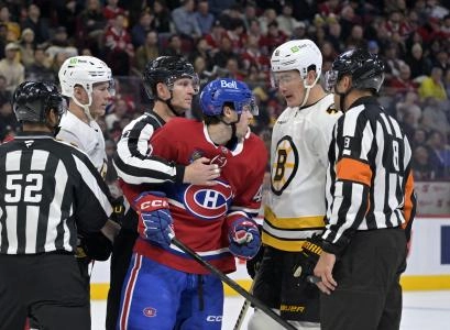 Nov 15, 2025; Montreal, Quebec, CAN; Montreal Canadiens forward Jared Davidson (49) exchanges words with Boston Bruins defenseman Nikita Zadorov (91) during the third period at the Bell Centre. Mandatory Credit: Eric Bolte-Imagn Images