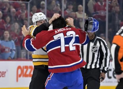 Nov 15, 2025; Montreal, Quebec, CAN; Boston Bruins forward Tanner Jeannot (84) fights Montreal Canadiens defenseman Arber Xhekaj (72) during the first period at the Bell Centre. Mandatory Credit: Eric Bolte-Imagn Images