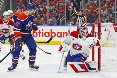 Mar 6, 2025; Edmonton, Alberta, CAN; Edmonton Oilers forward Zach Hyman (18) watches a shot go just wide of Montreal Canadiens goaltender Sam Montembeault (35) during the first period at Rogers Place.