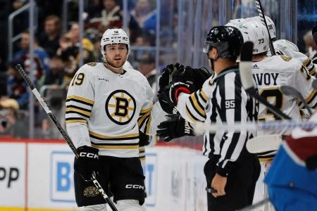 Jan 8, 2024; Denver, Colorado, USA; Boston Bruins center Johnny Beecher (19) celebrates with the bench after his goal in the second period against the Colorado Avalanche at Ball Arena.