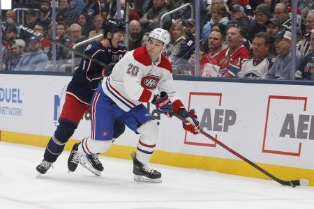 Nov 17, 2025; Columbus, Ohio, USA; Montreal Canadiens left wing Juraj Slafkovsky (20) looks to pass as Columbus Blue Jackets defenseman Zach Werenski (8) defends during the first period at Nationwide Arena. Mandatory Credit: Russell LaBounty-Imagn Images