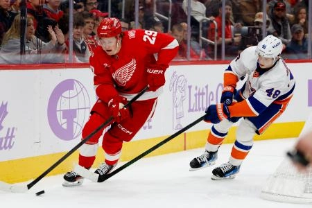 Oct 23, 2025; Elmont, New York, USA; New York Islanders defenseman Matthew Schaefer (48) skates from behind the net chased by Detroit Red Wings left wing Lucas Raymond (23) during the first period at UBS Arena.