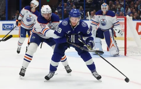 Oilers' defenseman Alec Regula ckecks Tampa Bays' Jake Guentzel