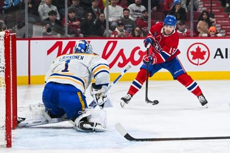 Dec 17, 2024; Montreal, Quebec, CAN; Montreal Canadiens center Alex Newhook (15) shoots the puck agianst Buffalo Sabres goalie Ukko-Pekka Luukkonen (1) during the second period at Bell Centre. Mandatory Credit: David Kirouac-Imagn Images