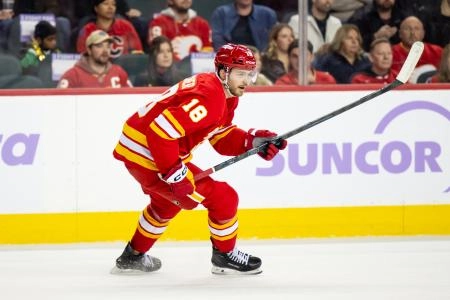 Nov 22, 2025; Calgary, Alberta, CAN; Calgary Flames center John Beecher (18) skates against the Dallas Stars during the first period at Scotiabank Saddledome. Mandatory Credit: Brett Holmes-Imagn Images